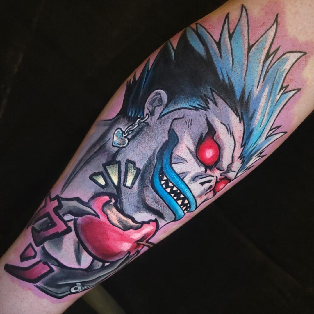 A tattoo of a demon with red eyes.