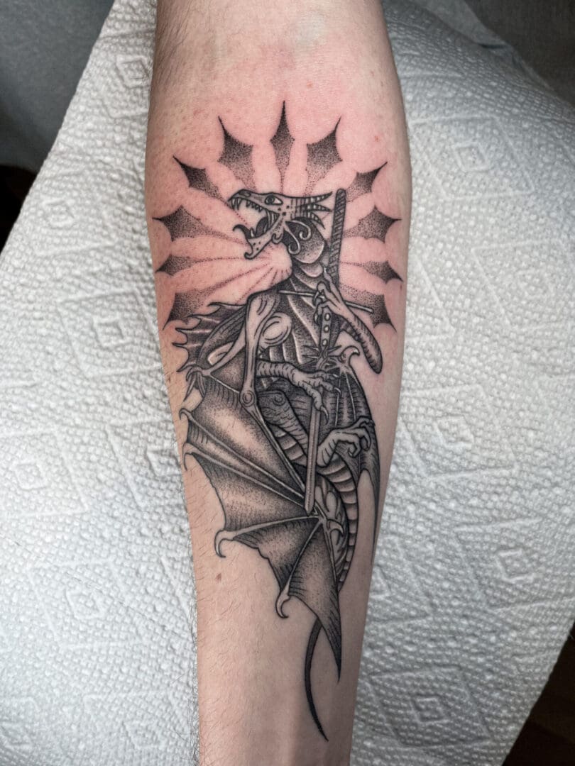 A dragon tattoo is shown on the arm.